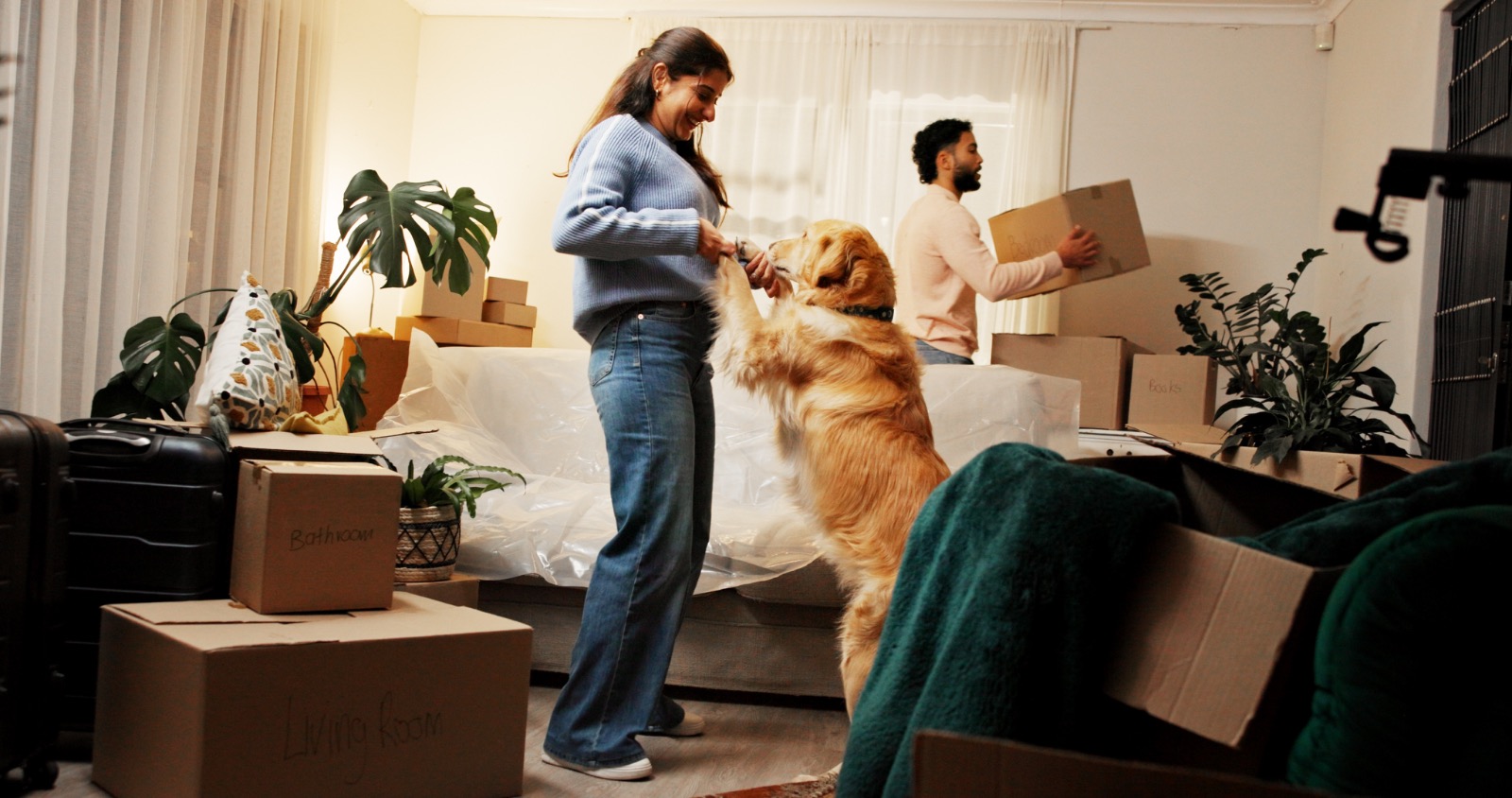 Couple unpacking boxes in their new home